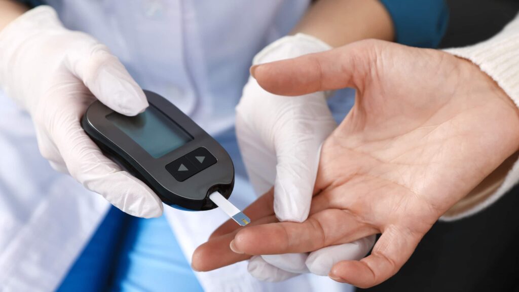 Doctor checking blood sugar levels during diabetes screening.