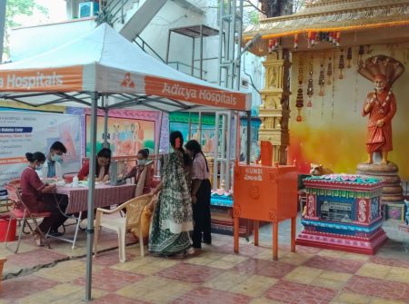 Outdoor diabetes screening camp setup by Aditya Hospitals near temple