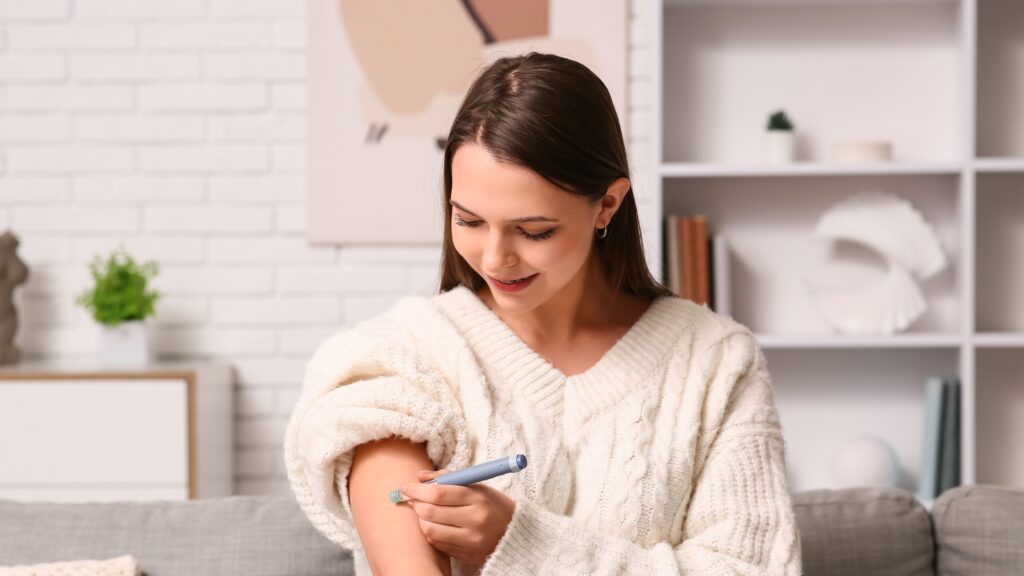 Woman checking blood sugar levels at home as part of pre-diabetes screening and diabetes prevention