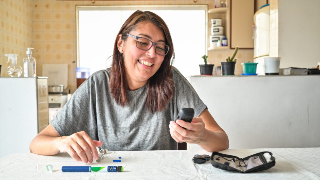 Happy person holding blood sugar report showing controlled diabetes through healthy lifestyle changes