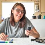 Happy person holding blood sugar report showing controlled diabetes through healthy lifestyle changes