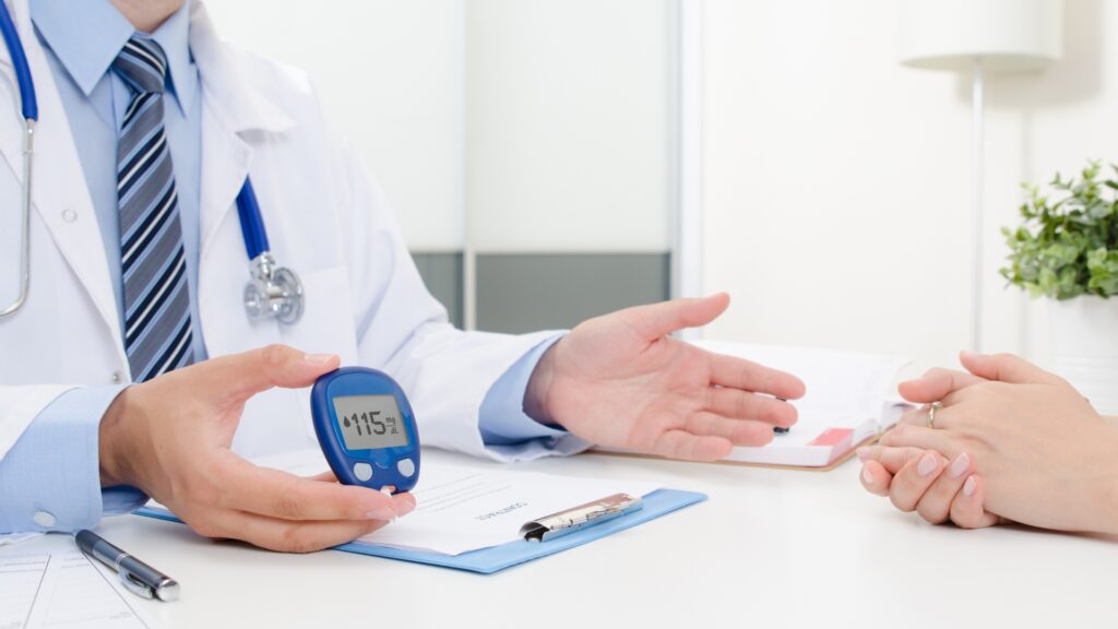 Doctor explaining early signs of diabetes to a patient during a consultation at Aditya Hospitals.