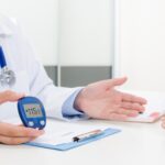 Doctor explaining early signs of diabetes to a patient during a consultation at Aditya Hospitals.
