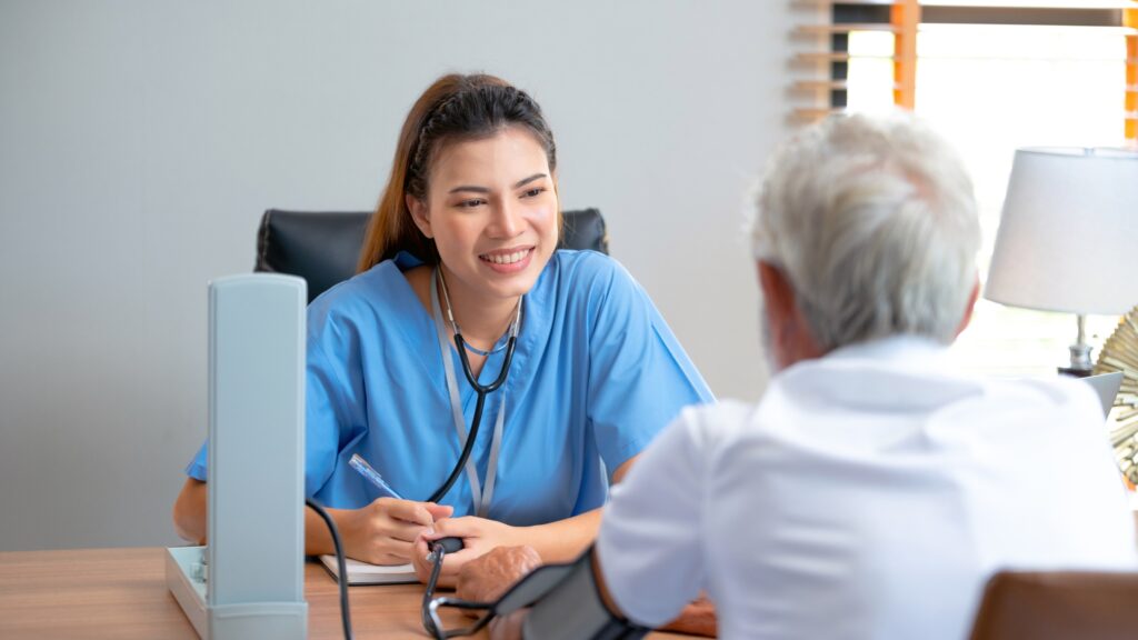 Doctor checking blood pressure of an elderly patient during a diabetes health checkup