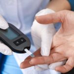 Doctor checking blood sugar levels during diabetes screening.