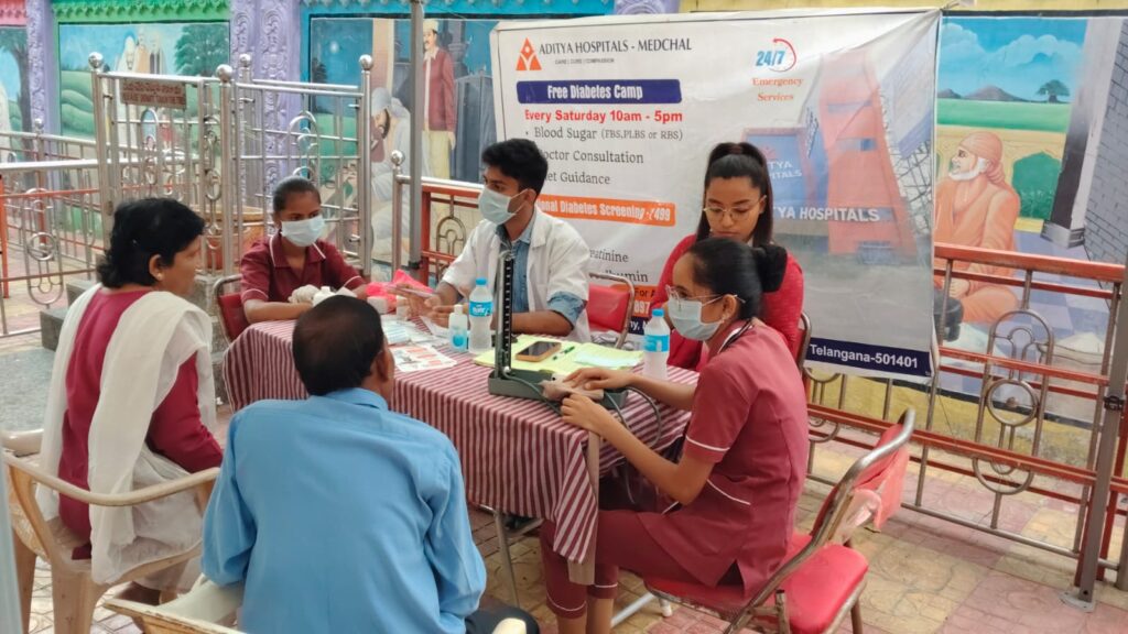 Medical team providing diabetes consultation and glucose testing at health camp
